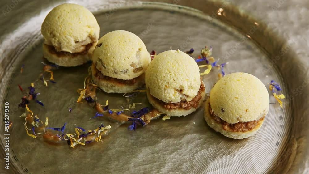 zoom out from trendy decorated four spherical sponge biscuits spinning on plate zoom out from trendy decorated four spherical sponge biscuits spinning on plate