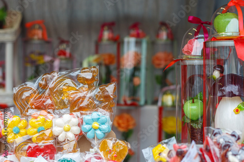 Showcase with sweets on a stick in a gift box.
