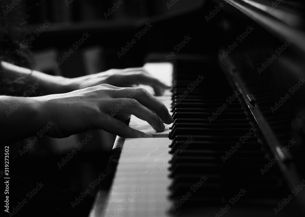 Black and White Image of Hands on Piano Keys