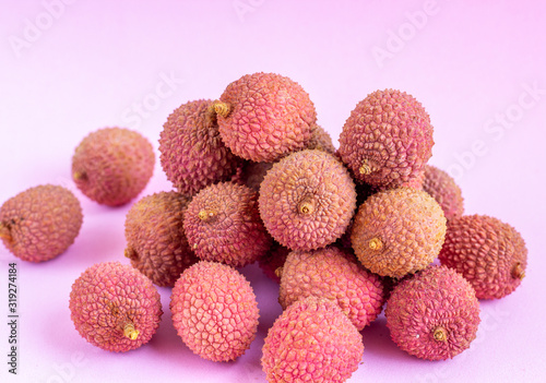 Tropical lychee fruit on a pink background.Selective focus.