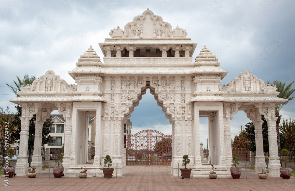 White Houston Hindu temple gate on a cloudy day