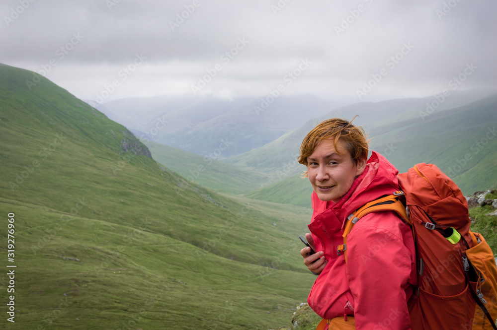 Female hiker on the slopes of munro in Scotland