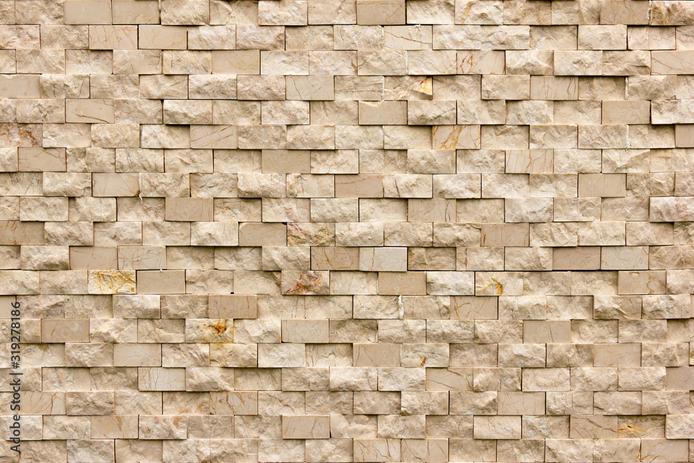 Rectangular marble tiles in beige color. Beige marble wall texture Wallpaper background