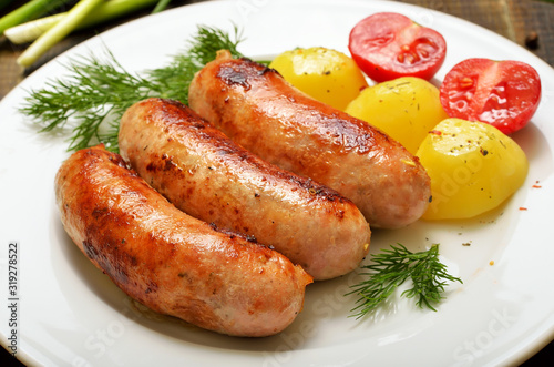 Grilled sausages and boiled potatoes