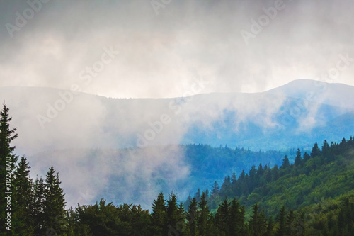 White thick clouds cover the mountains. Mountain landscape_