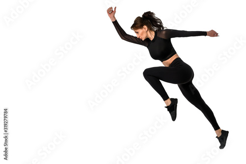 Sporty woman runner in silhouette on white background. Photo of attractive woman in fashionable sportswear. Dynamic movement. Side view. Sport and healthy lifestyle
