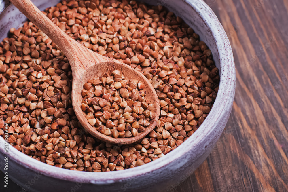 A wooden spoon of buckwheat close-up. A wooden spoon of buckwheat close-up.