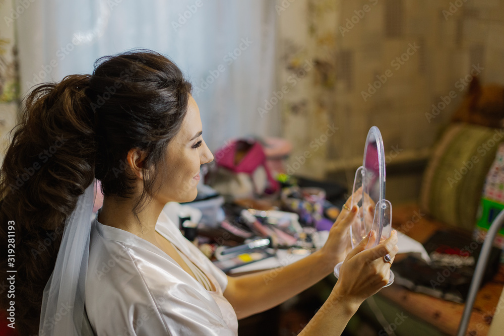 Beautiful woman looking at herself in the mirror.