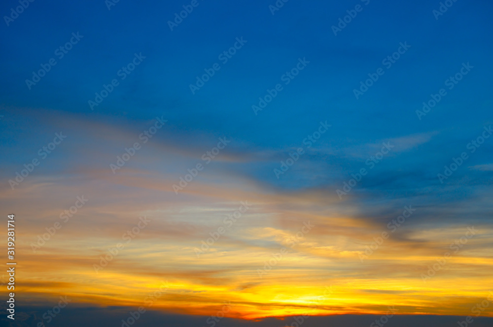 Cloudy sky and bright sunrise over the horizon.