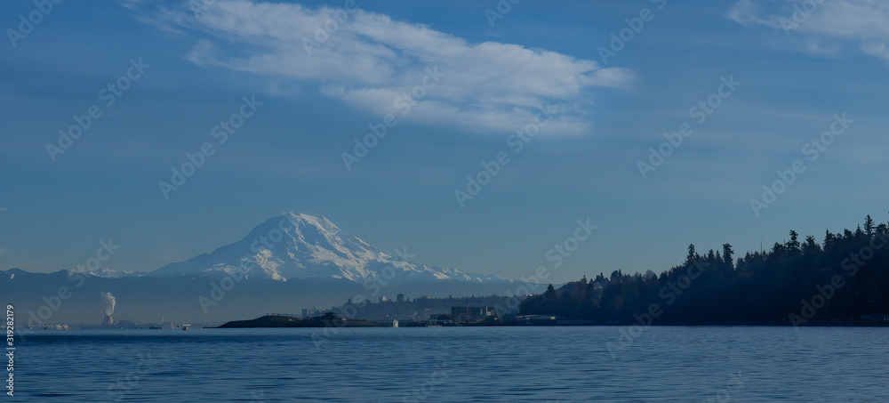Panorama of Mt. Rainier with Tacoma Washington and Pt Defiance Park in foreground taken from Puget Sound