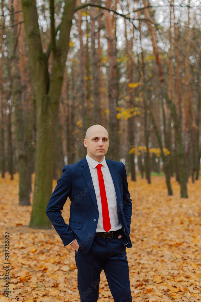 Handsome stylish man in a jacket in the autumn in the forest. Handsome stylish man in a jacket in the autumn in the forest.