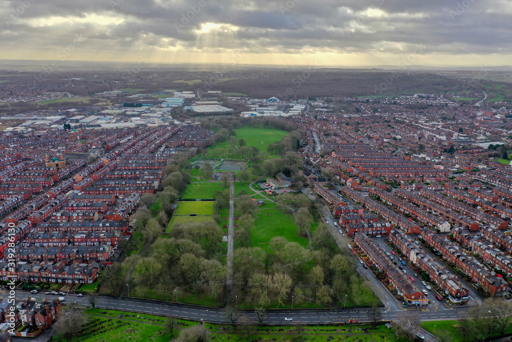 Aerial photo of the village of Beeston in Leeds West Yorkshire showing a typical British park along side rows of terrace houses, roads and streets, taken in the winter time on a wet cold day. Aerial photo of the village of Beeston in Leeds West Yorkshire showing a typical British park along side rows of terrace houses, roads and streets, taken in the winter time on a wet cold day.