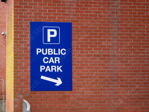 Sign to Public Car Park on a brick wall