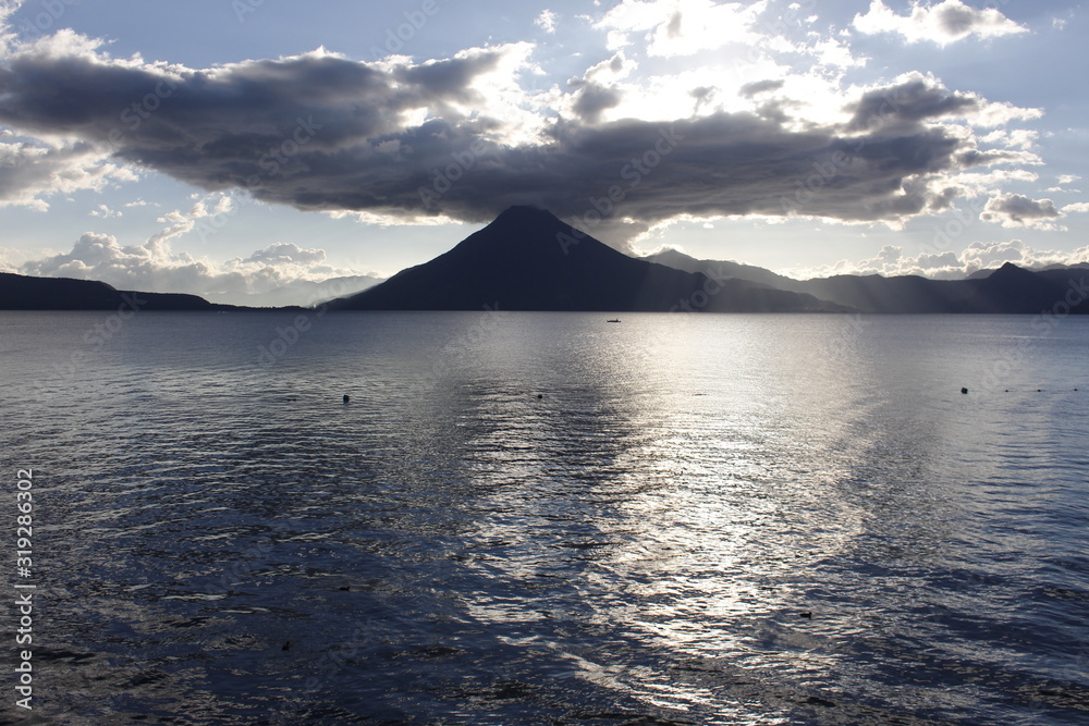 Sunset at lake of atitlan Guatemala - cloudy day at Panajachel Solola - Lake surrounded by mountains and volcanoes