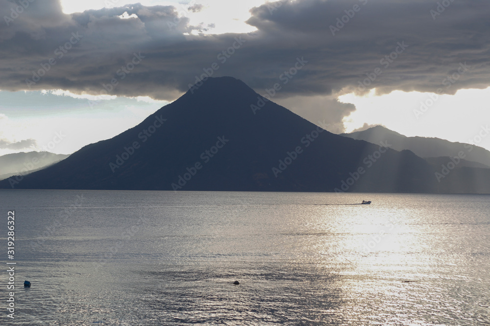Sunset at lake of atitlan Guatemala - cloudy day at Panajachel Solola - Lake surrounded by mountains and volcanoes
