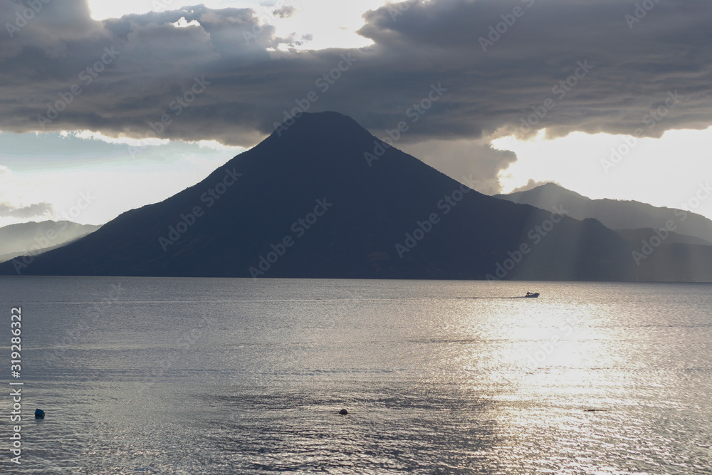 Sunset at lake of atitlan Guatemala - cloudy day at Panajachel Solola - Lake surrounded by mountains and volcanoes Sunset at lake of atitlan Guatemala - cloudy day at Panajachel Solola - Lake surrounded by mountains and volcanoes