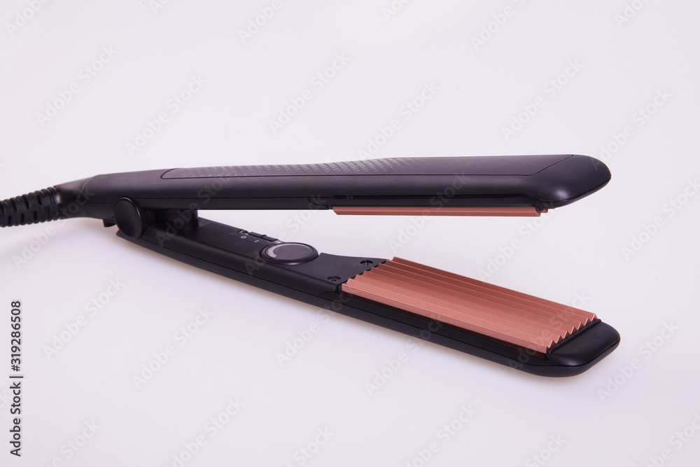 Hair corrugation iron on a white background. Barber tools, hairdressing concept Hair corrugation iron on a white background. Barber tools, hairdressing concept