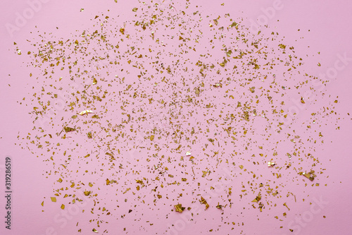 Pink festive background with golden confetti.