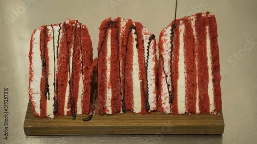 Chocolate icing on cake. Chocolate glaze pouring on homemade dessert. Close up of biscuit cake decoration. Topping dessert
