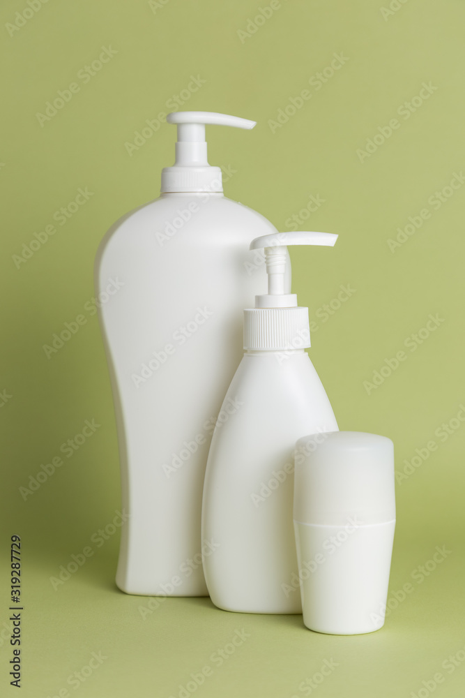 White plastic soap dispensers and deodorant. Copy space. Place for text. White plastic soap dispensers and deodorant. Copy space. Place for text.