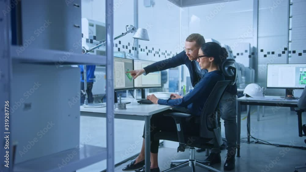 Modern Electronics Factory: Male Supervisor Talks to a Female Electrical Engineer who Works on Computer with CAD Software. Developing PCB, Microchips, Semiconductors and Telecommunications Equipment Modern Electronics Factory: Male Supervisor Talks to a Female Electrical Engineer who Works on Computer with CAD Software. Developing PCB, Microchips, Semiconductors and Telecommunications Equipment