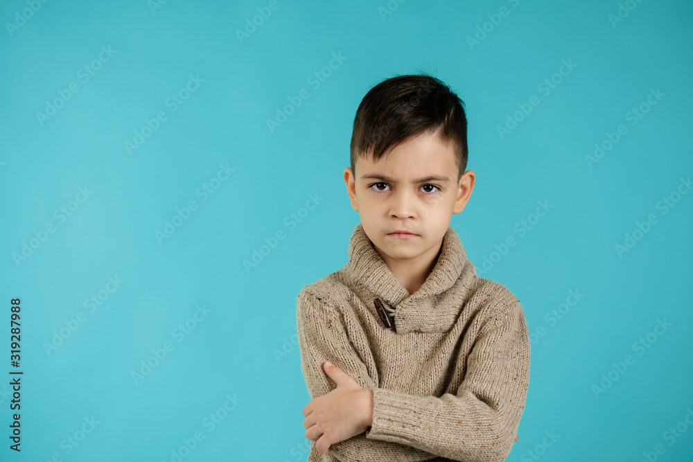 offended sad little child boy on blue background. Human emotions and facial expression offended sad little child boy on blue background. Human emotions and facial expression
