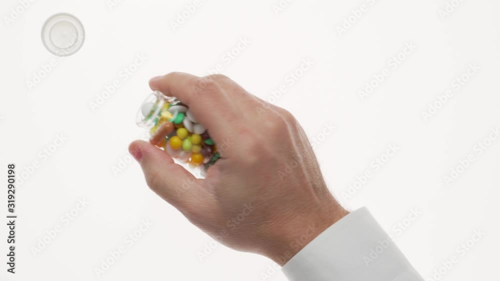 Man hand with pills, tablets, vitamins, drugs, capsules isolated on white background. White shirt, business style. Health care concept. Pharmaceutical industry. Pharmacy. Man hand with pills, tablets, vitamins, drugs, capsules isolated on white background. White shirt, business style. Health care concept. Pharmaceutical industry. Pharmacy.