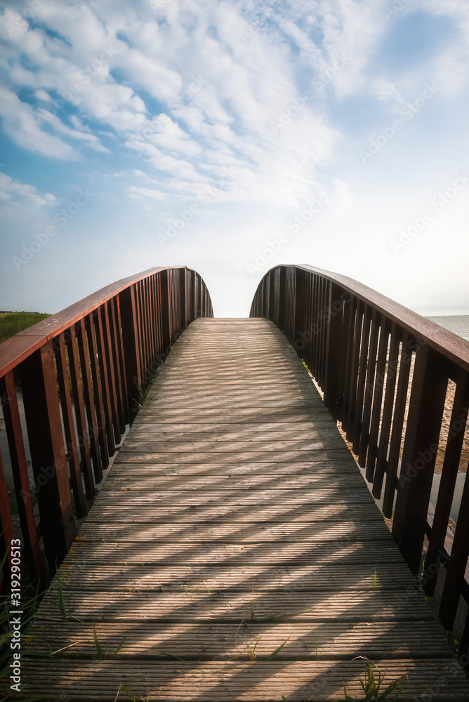 Bridge going up toward sky. Walkway on Sylt island, at North sea
