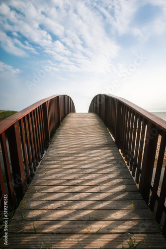 Bridge going up toward sky. Walkway on Sylt island  at North sea