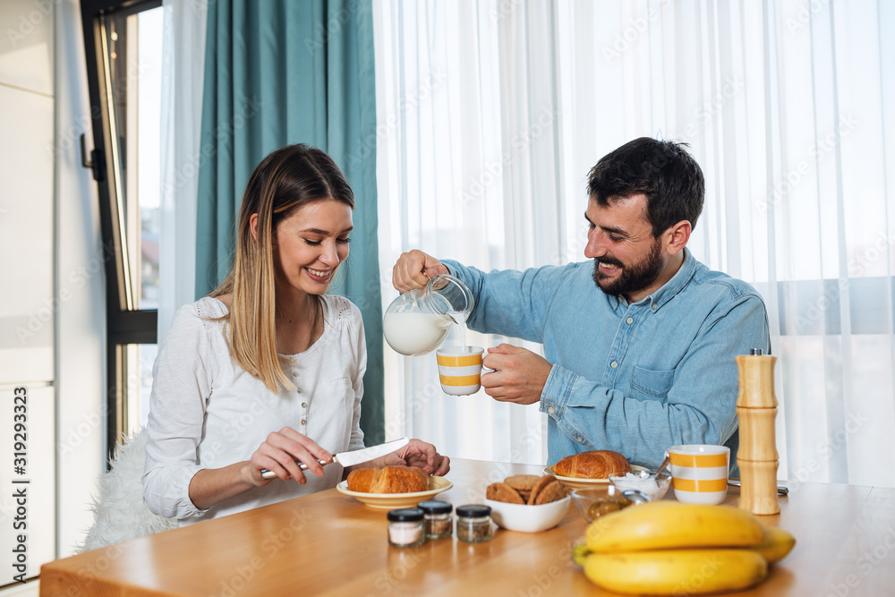 Happy young love couple have breakfast at home