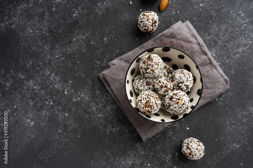 Raw sweets from nuts and dates on a black background