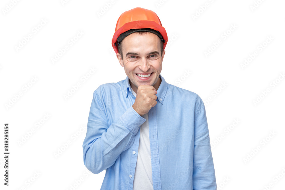 Cheerful builder in helmet giggles at the camera, isolated background, copy space Cheerful builder in helmet giggles at the camera, isolated background, copy space