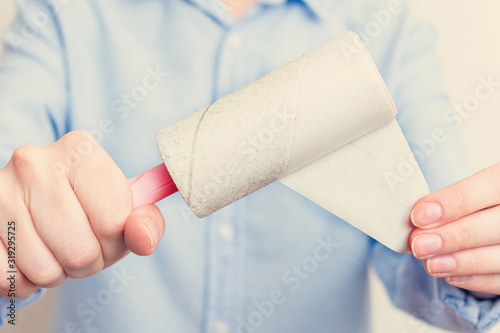Person shows one-time paper roller with adhered dust, close up