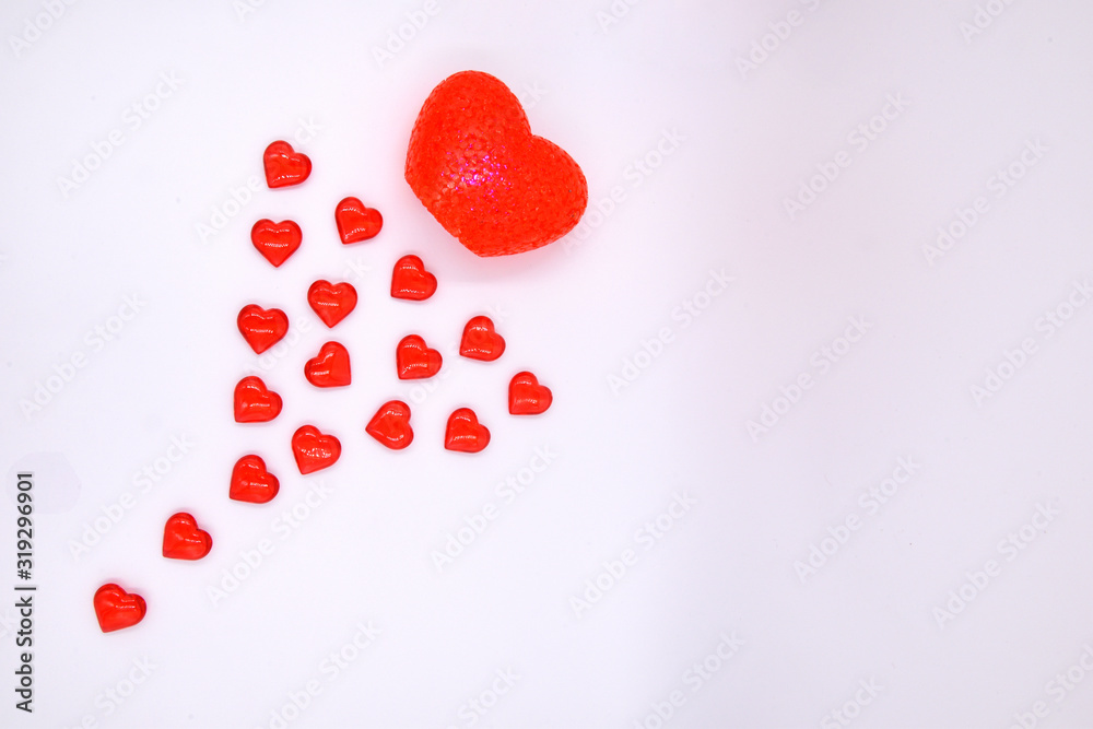 A large heart flies on a white background, followed by a tail of small red hearts. A trace of hearts.