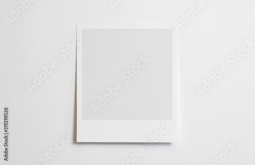Blank polaroid photo frame with soft shadows tape isolated on white paper background as template for graphic designers presentations, portfolios etc. photo