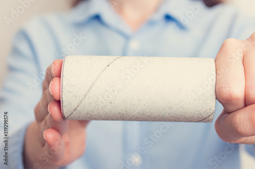 Person shows one-time paper roller with adhered dust, close up