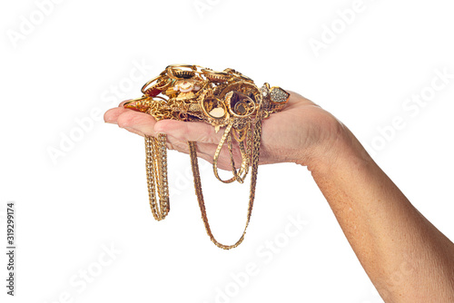 Woman’s Hand Holding Gold Jewelry