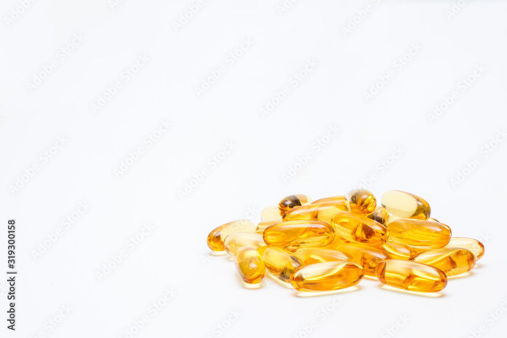 Fish oil capsules, close-up, isolated on a white background, with copy space. Concept vitamins for skin and hair. Fish oil capsules, close-up, isolated on a white background, with copy space. Concept vitamins for skin and hair.