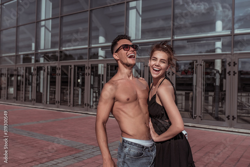 Happy cheerful couple man girl laughing  dancers trained tanned torso  sport dancing  summer city  hip hop  style dancing  youth lifestyle. Street urban fitness.