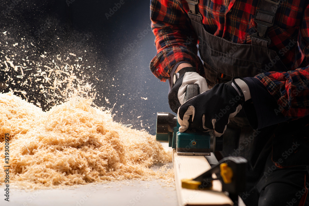 Carpenter works with electrical planer Carpenter works with electrical planer