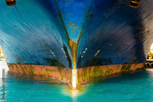 View of very large container ship bow part. Metal is damaged and rusty.
