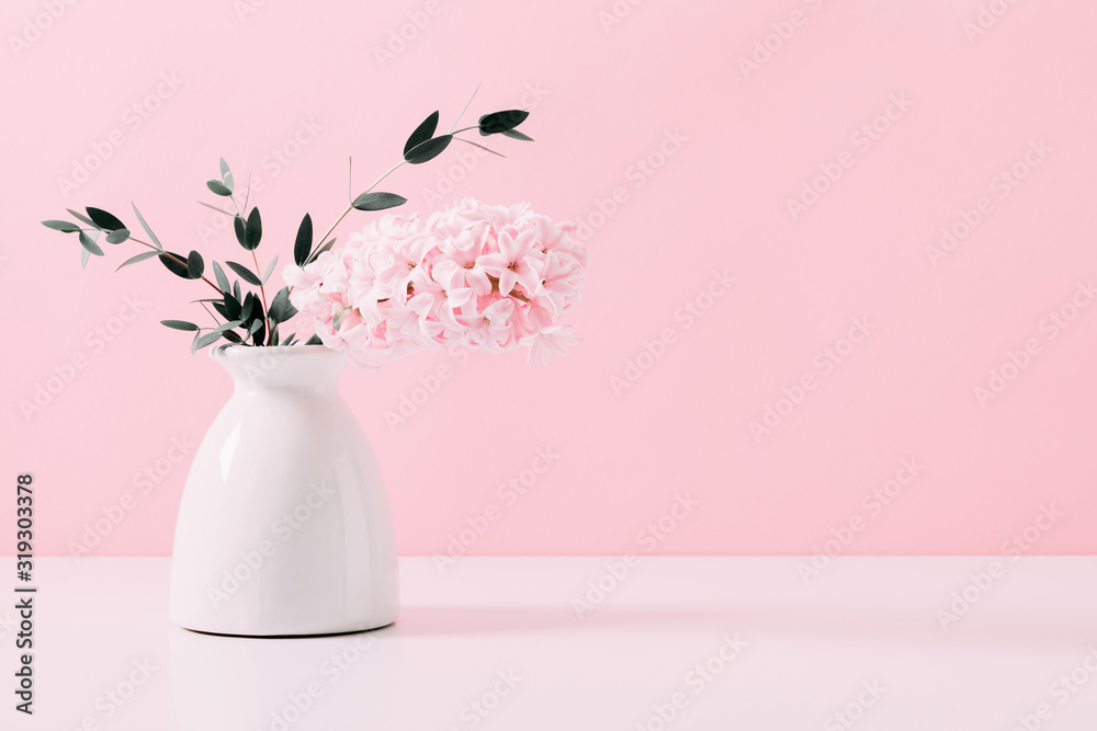 Pink hyacinth, eucalyptus on pink wall background. Spring flower hyacinth in vase on pink background. Pink hyacinth, eucalyptus on pink wall background. Spring flower hyacinth in vase on pink background.