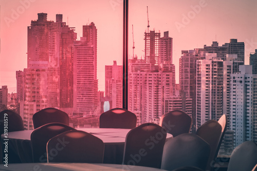 empty conference room with view over modern skyline during sunset -