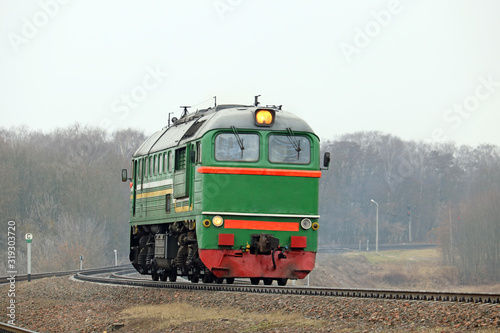 old diesel locomotive moving to a train station