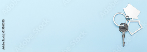 фотографія House keys with trinket on color background, top view with copy space