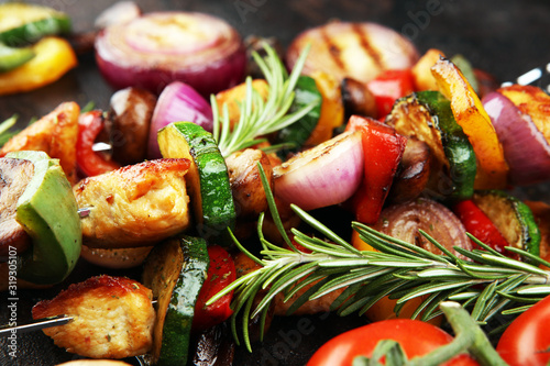 Grilled pork shish or kebab on skewers with vegetables . Food background shashlik