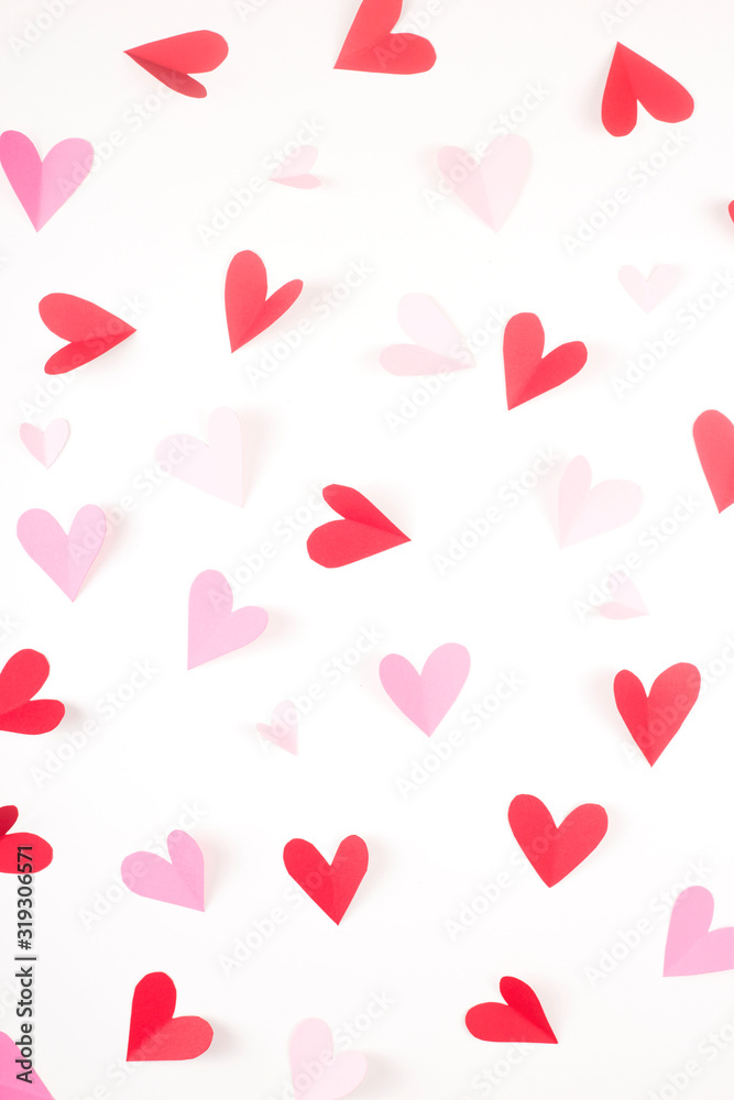 Red and pink hearts made of paper on a white background. Valentine's day and love concept.