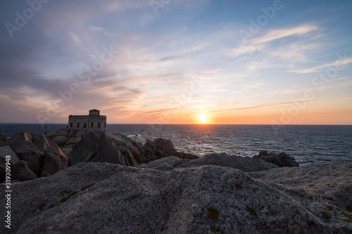 Sunset at the Capotesta lighthouse in Sardinia photo