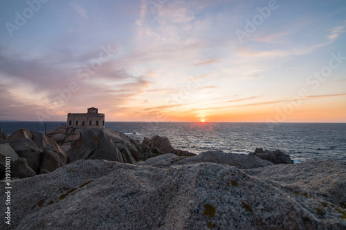 Sunset at the Capotesta lighthouse in Sardinia photo