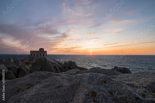 Sunset at the Capotesta lighthouse in Sardinia photo